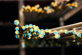 Color coded industrial bars highlighting the importance of metal certification and material traceability.