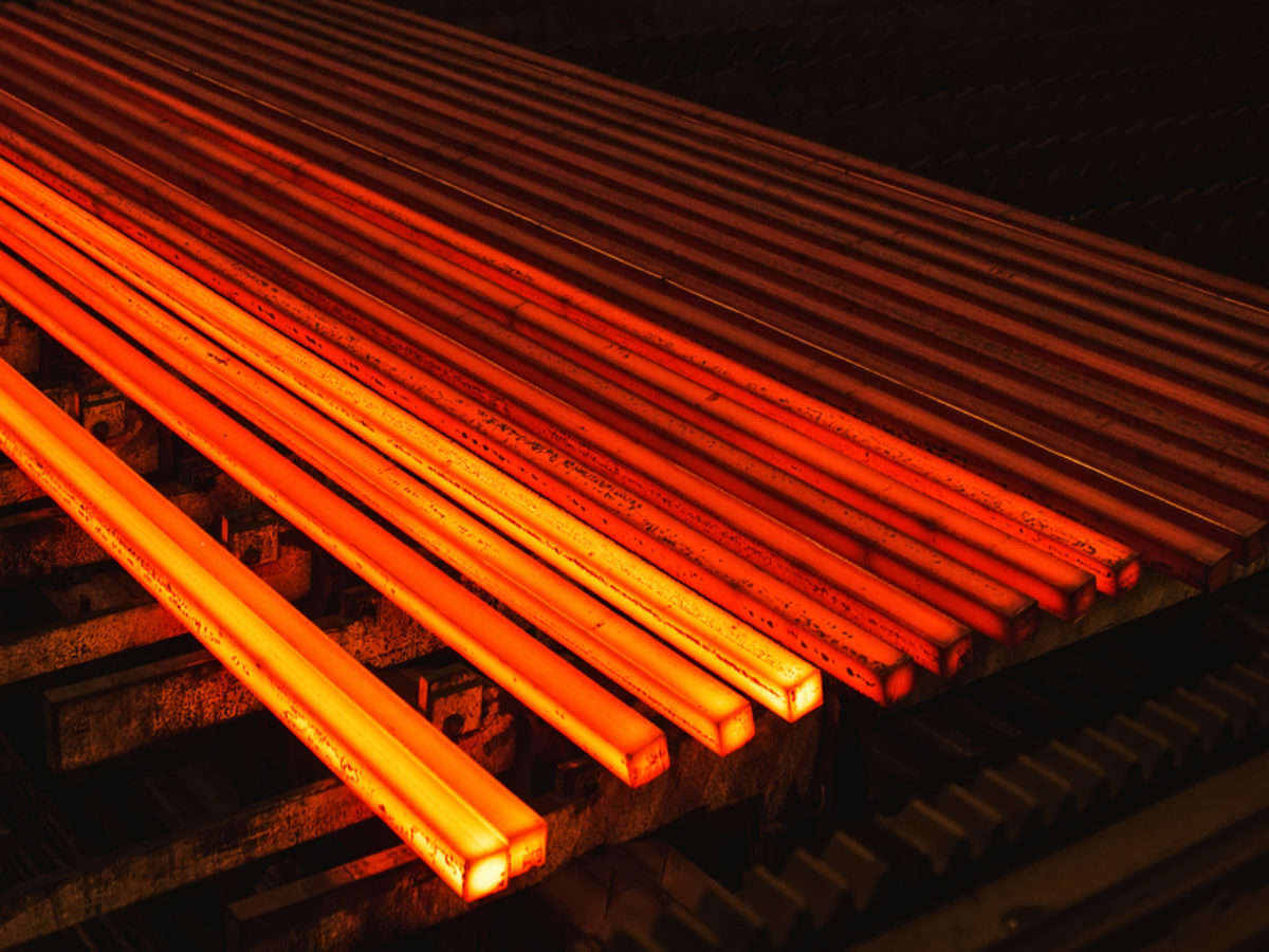 Glowing alloy bars undergoing the tool steel heat treatment process for maximum industrial performance.
